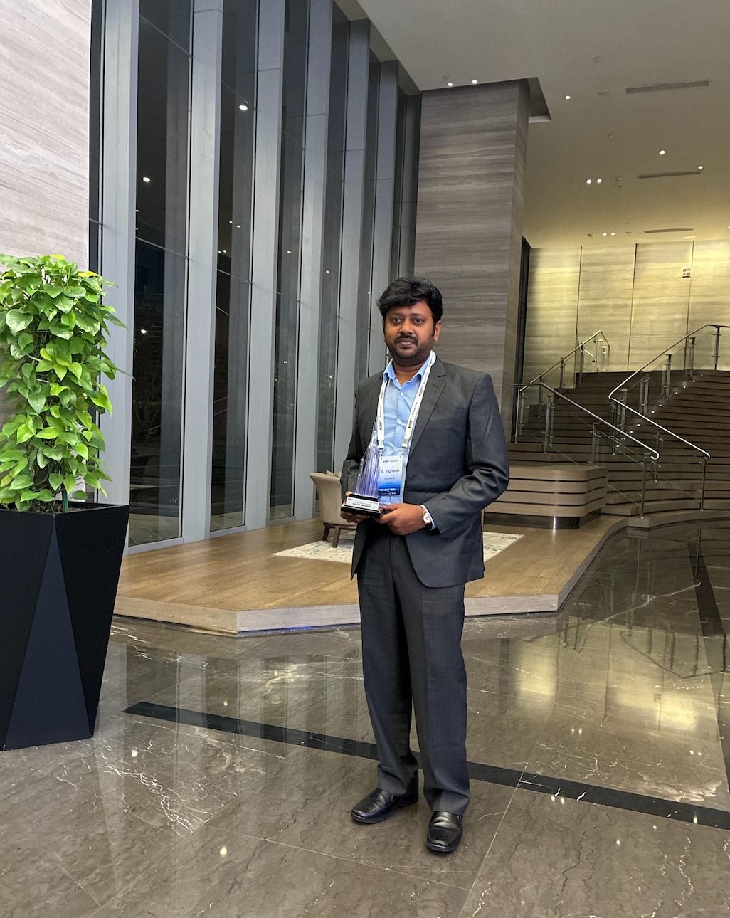 Nilam Insights co-founders with the event speaker and the AI Paradigm Disruptor trophy