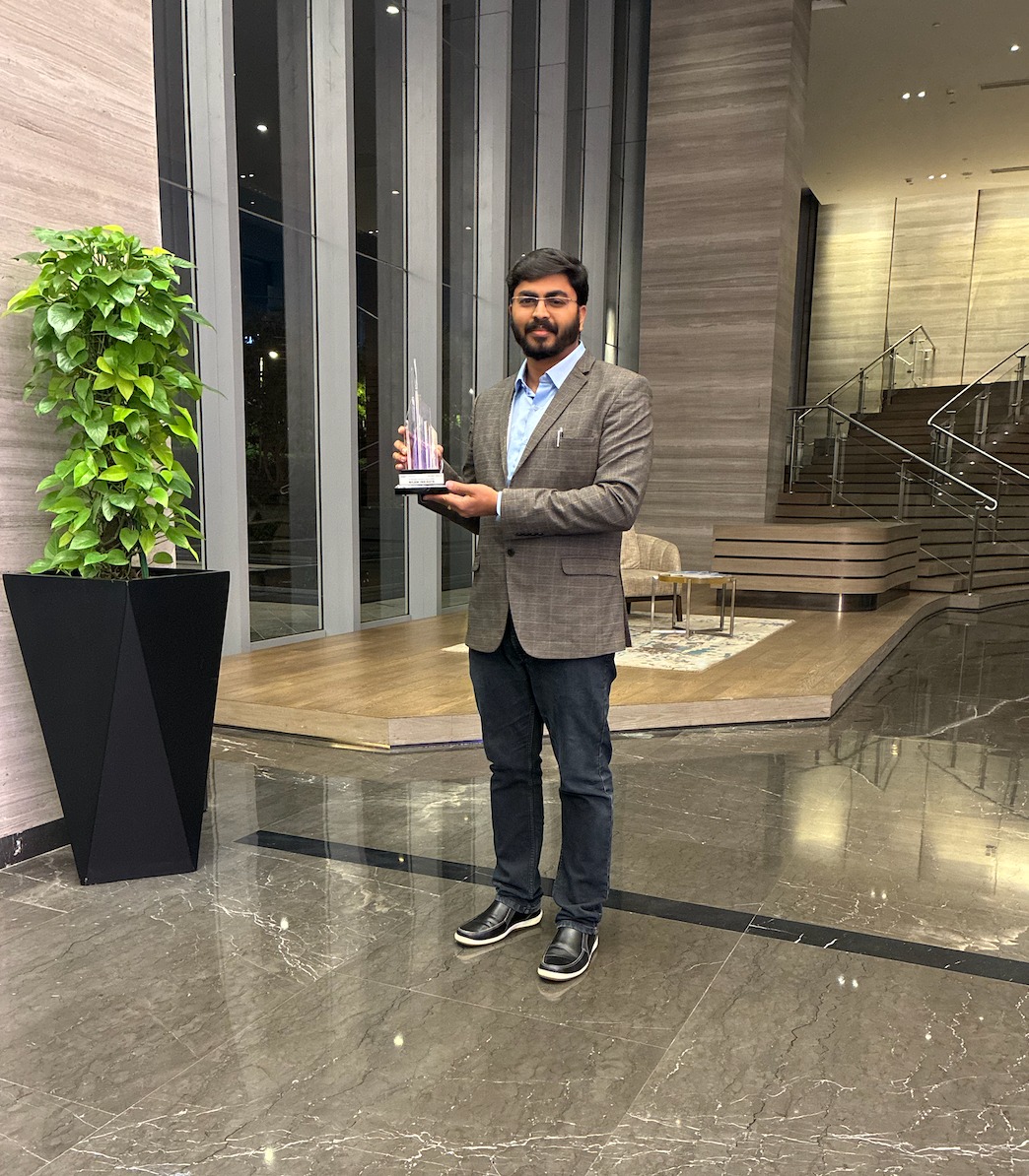 Nilam Insights leadership with the AI Paradigm Disruptor 2026 trophy in the hotel lobby